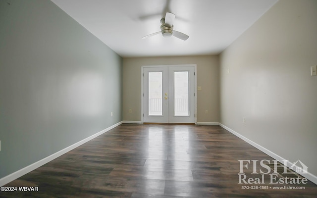 spare room with ceiling fan, dark hardwood / wood-style flooring, and french doors