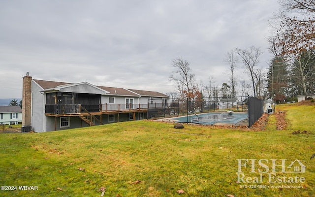 view of yard with central AC, a sunroom, and a covered pool