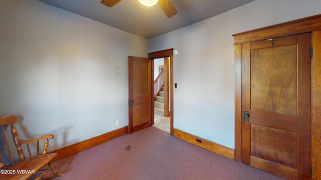 spare room with ceiling fan and light colored carpet