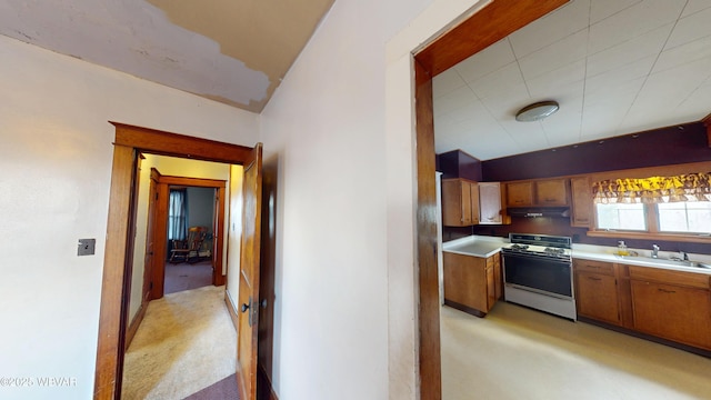 kitchen featuring white range and sink