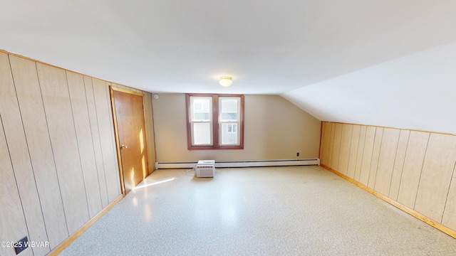 bonus room featuring wooden walls and vaulted ceiling