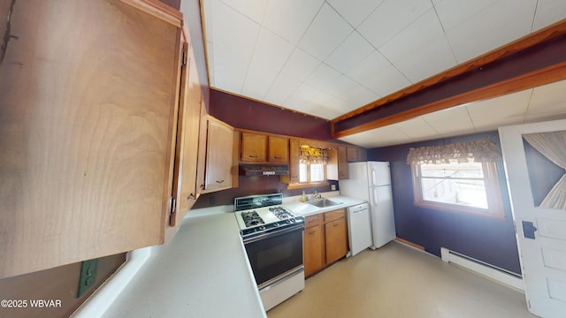 kitchen with beamed ceiling, white appliances, and sink