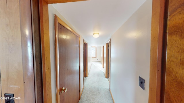 hallway featuring light carpet