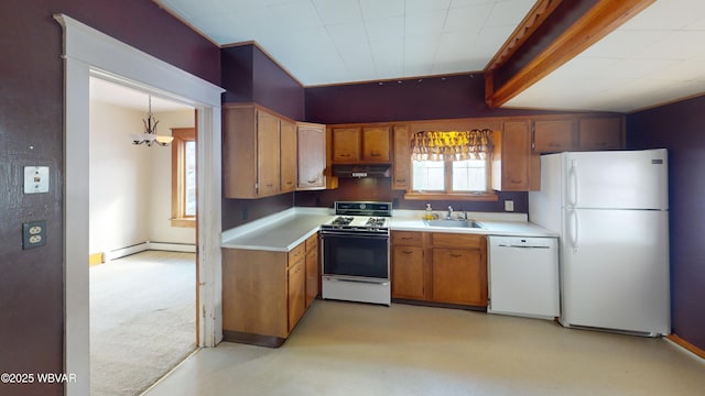 kitchen with pendant lighting, white appliances, baseboard heating, and sink