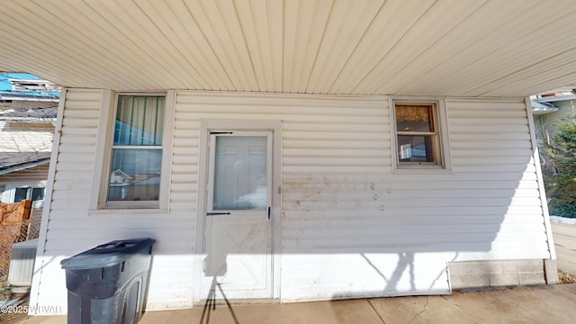 view of side of home with central AC