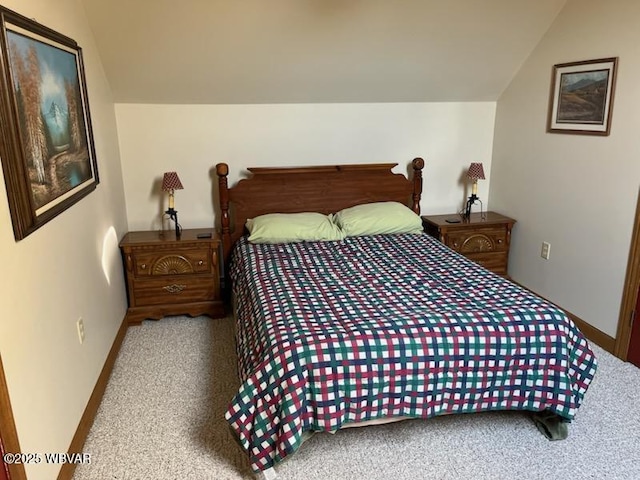 carpeted bedroom with vaulted ceiling and baseboards