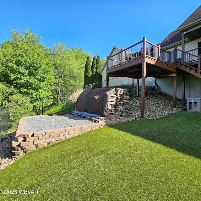 view of yard featuring a wooden deck and central air condition unit