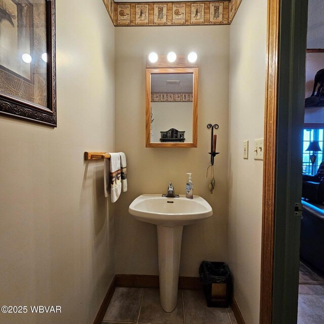 bathroom featuring baseboards and tile patterned flooring