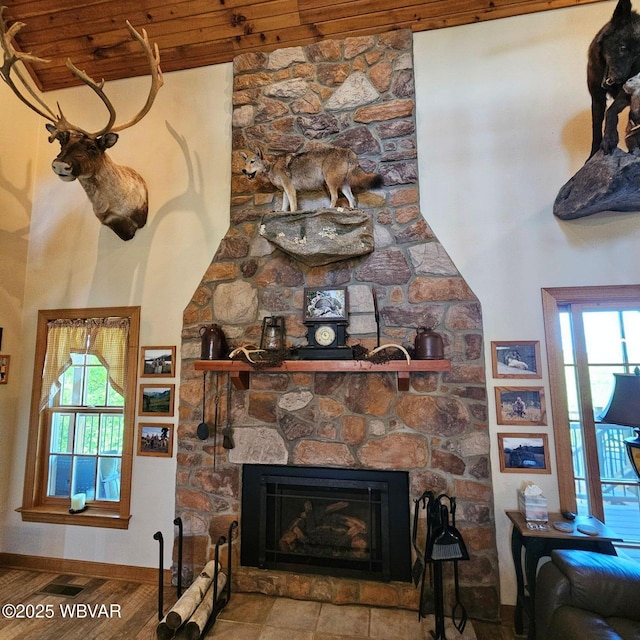 detailed view of a fireplace, wood finished floors, and baseboards