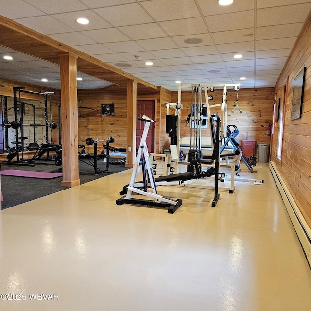 exercise area with wooden walls, baseboard heating, and recessed lighting