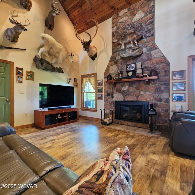 living room featuring high vaulted ceiling, wooden ceiling, wood finished floors, a fireplace, and beamed ceiling