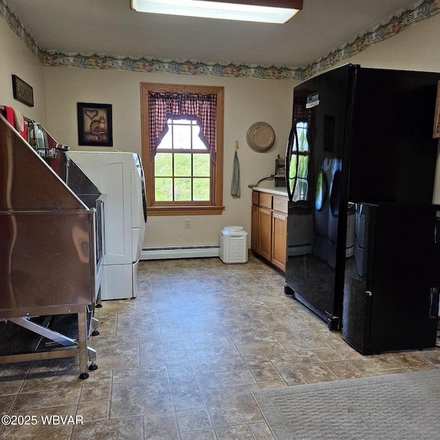miscellaneous room featuring baseboard heating and washer / clothes dryer