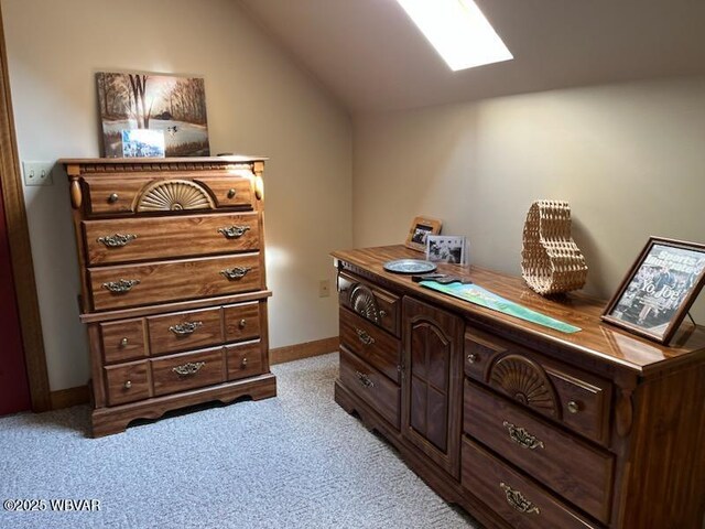 office with light carpet, a skylight, lofted ceiling, and baseboards