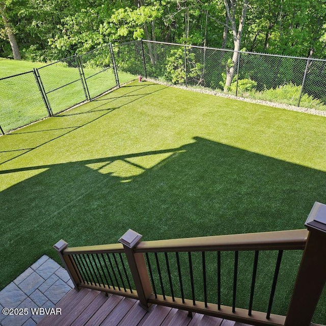 view of yard with a wooden deck and a gate