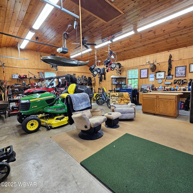 garage with wooden walls, a workshop area, and a garage door opener