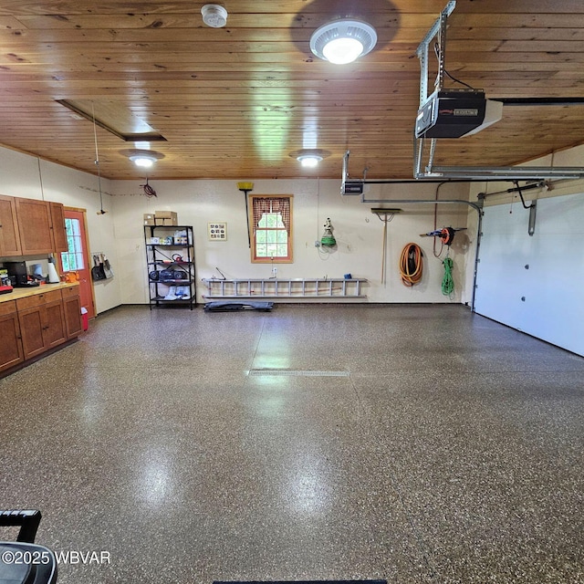 garage with a garage door opener and wooden ceiling