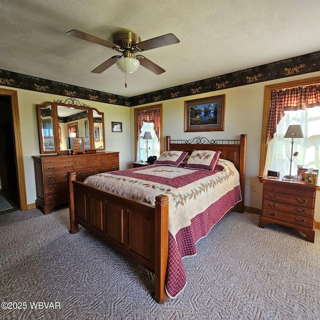 carpeted bedroom with a textured ceiling, ceiling fan, and baseboards