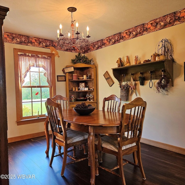 dining room with a chandelier, dark wood-style flooring, and baseboards