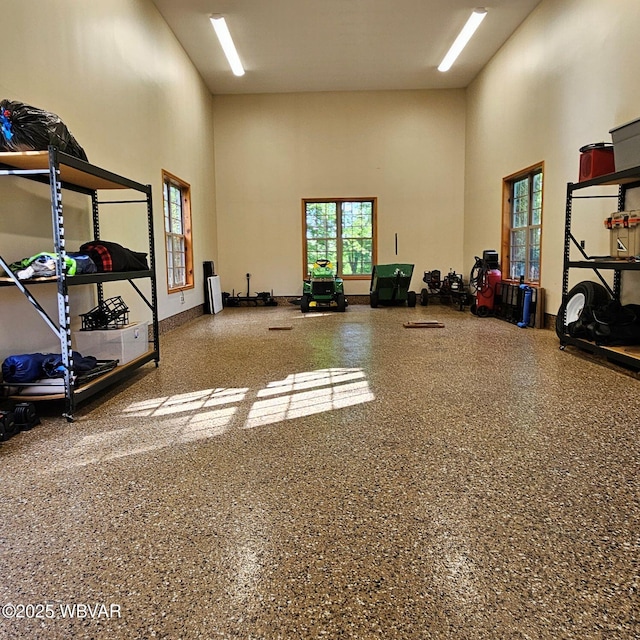 workout area with a high ceiling