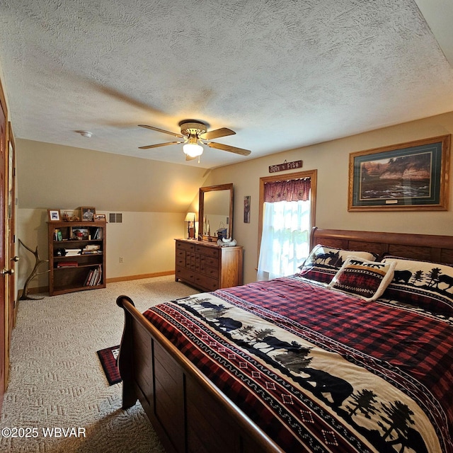 carpeted bedroom featuring baseboards, a textured ceiling, and ceiling fan