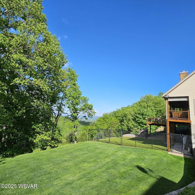 view of yard with a deck and a gate