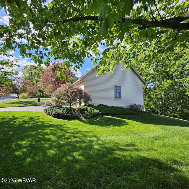 view of side of home featuring a yard