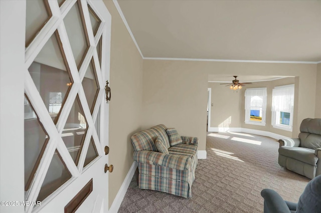 carpeted living room featuring baseboards and crown molding