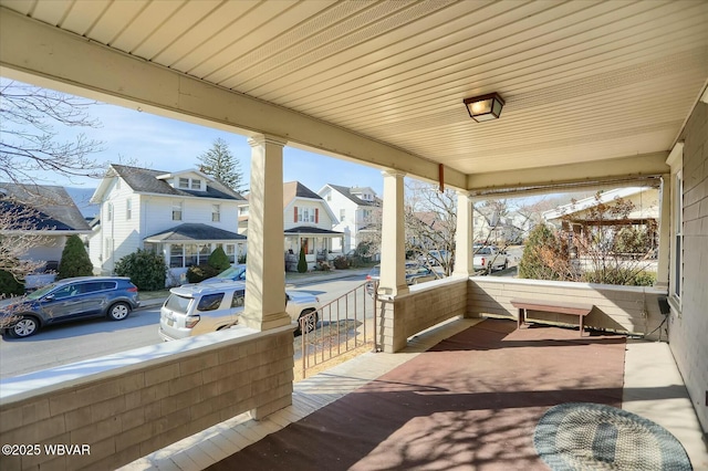 view of patio / terrace with a residential view and covered porch