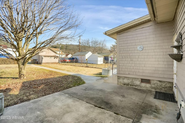 view of patio featuring fence and a residential view