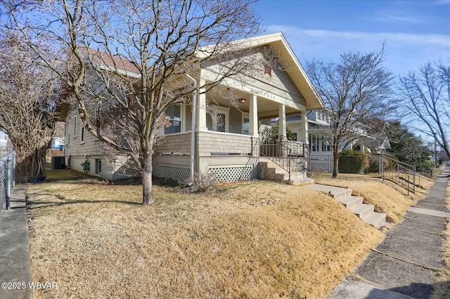 view of front of house featuring cooling unit, a porch, and fence