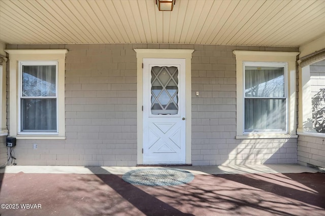 view of exterior entry featuring a porch