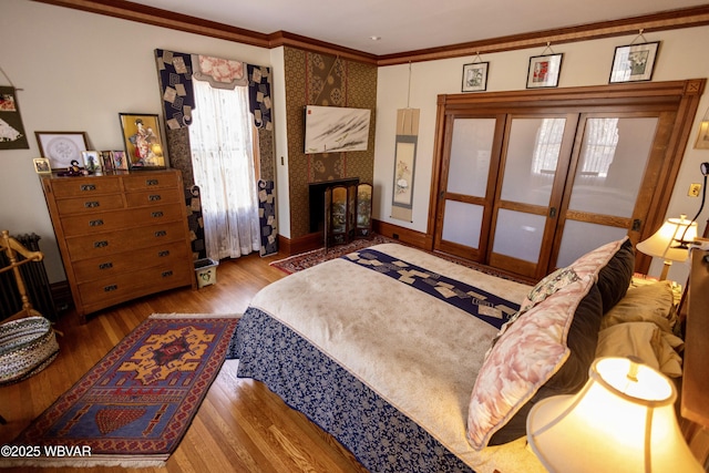 bedroom with crown molding and light wood-type flooring