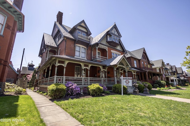 victorian home with a front lawn