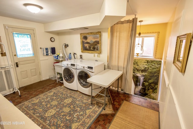 clothes washing area featuring washer and clothes dryer