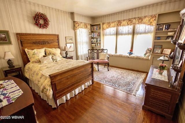 bedroom with dark hardwood / wood-style flooring