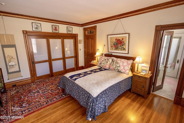 bedroom featuring wood-type flooring and ornamental molding