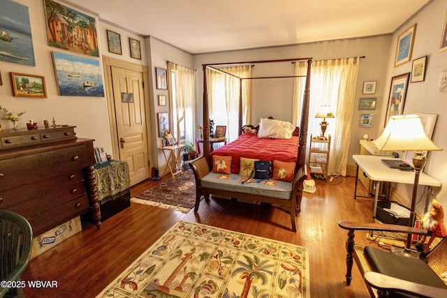 bedroom featuring hardwood / wood-style flooring and crown molding