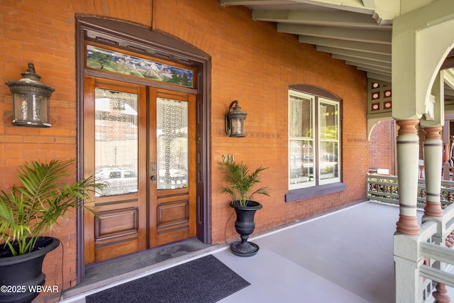 entrance to property with french doors and a porch