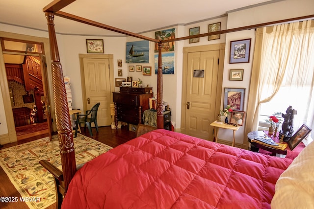 bedroom featuring crown molding and dark hardwood / wood-style floors