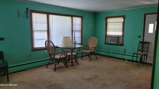 sitting room featuring carpet flooring, a wealth of natural light, cooling unit, and a baseboard heating unit