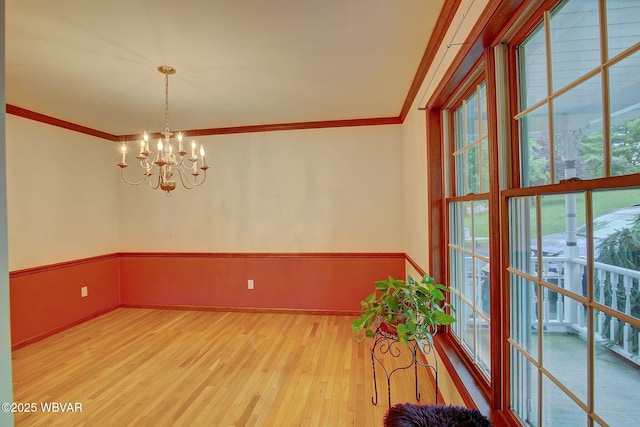 20 Hillcrest Dr, Cogan Station, PA 17728 - unfurnished dining area with wood finished floors, a chandelier, and ornamental molding