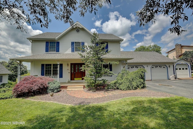 20 Hillcrest Dr, Cogan Station, PA 17728 - traditional-style home with covered porch, a garage, driveway, a front lawn, and roof with shingles