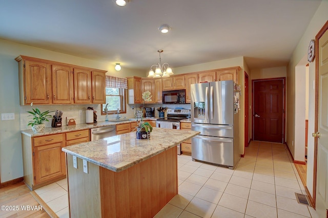 20 Hillcrest Dr, Cogan Station, PA 17728 - kitchen with stainless steel appliances, light stone counters, a chandelier, a kitchen island, and light tile patterned floors