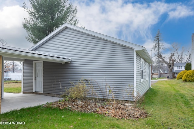 view of side of home featuring a lawn