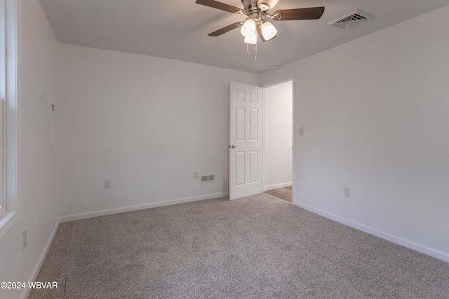 unfurnished room featuring light carpet and ceiling fan