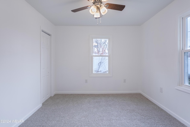 empty room featuring ceiling fan and carpet floors