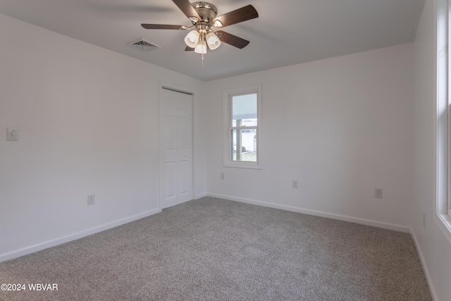 spare room featuring carpet floors and ceiling fan