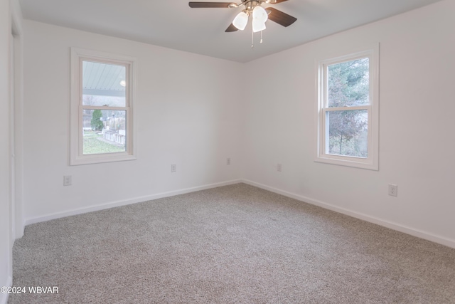 empty room featuring carpet flooring and ceiling fan