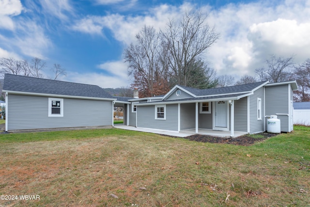 view of front of house with a patio area and a front yard