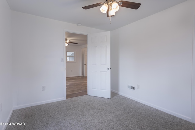 spare room featuring carpet and ceiling fan